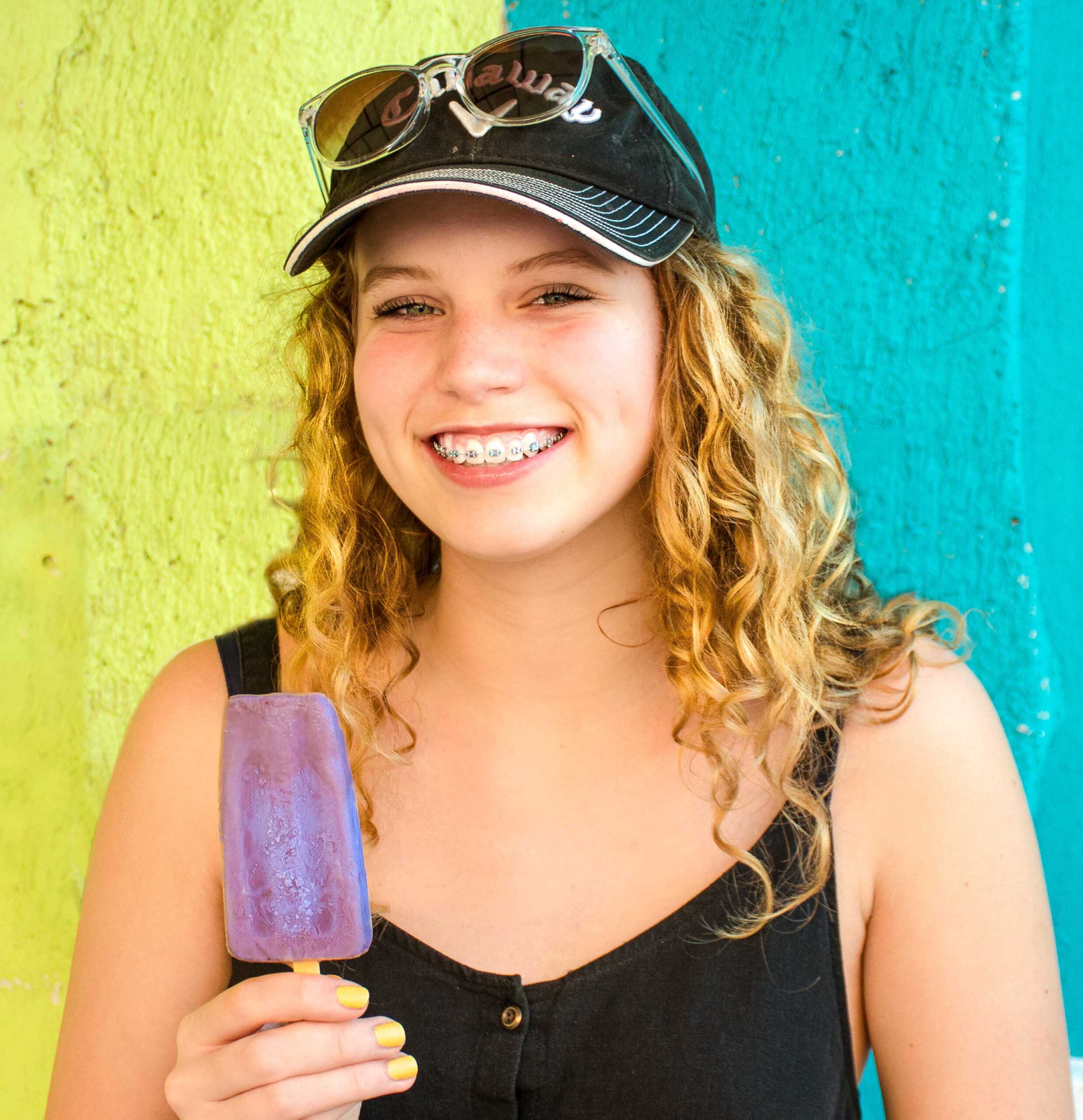 teenager with braces and a popsicle
